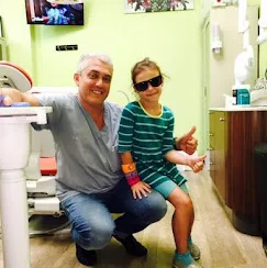 Dr. Yury Slepak with a young patient at Bite Squad Dental NYC